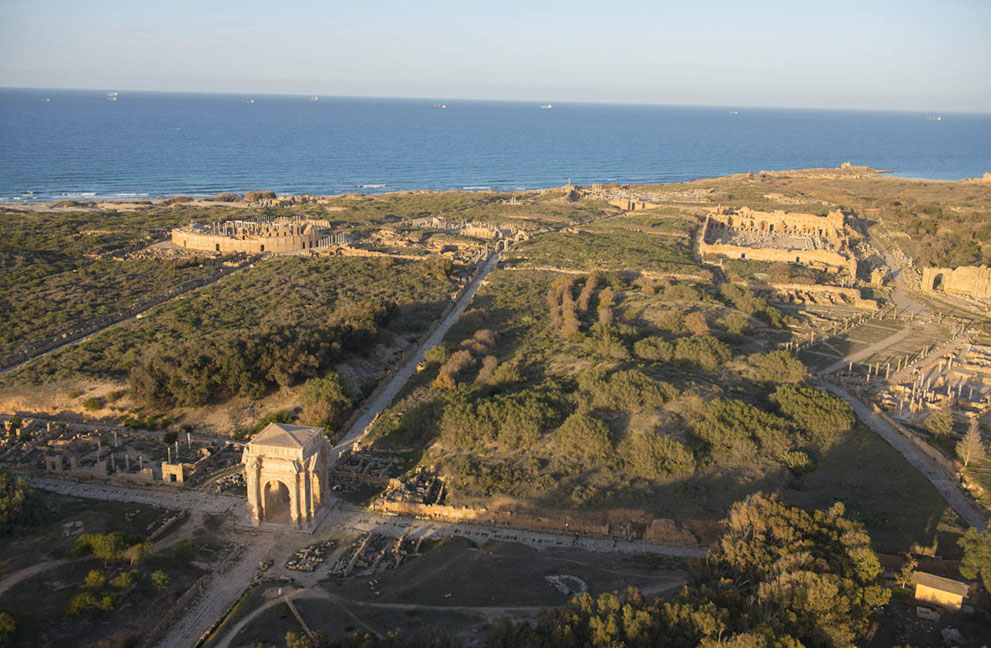 The site of Leptis Magna, with the Mediterranean behind. Founded 2,000 years ago as the Phoenician port of Lpgy, it was integrated into the Roman Empire in 46 BC, growing into a significant city soon after. Leptis Magna 26
